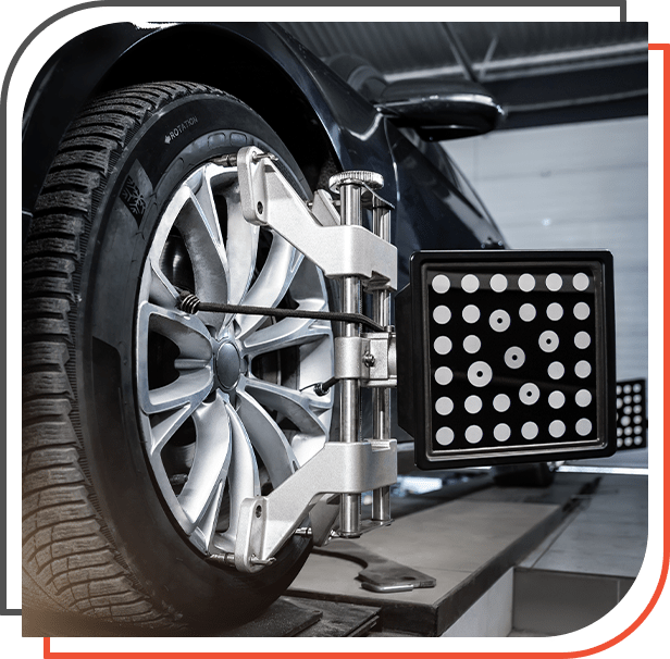 CLose-up car wheel indoors service maintenance repair center against laser sensor equipment diagnostics